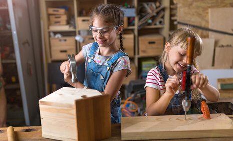 Zwei Mädchen bauen etwas aus Holz